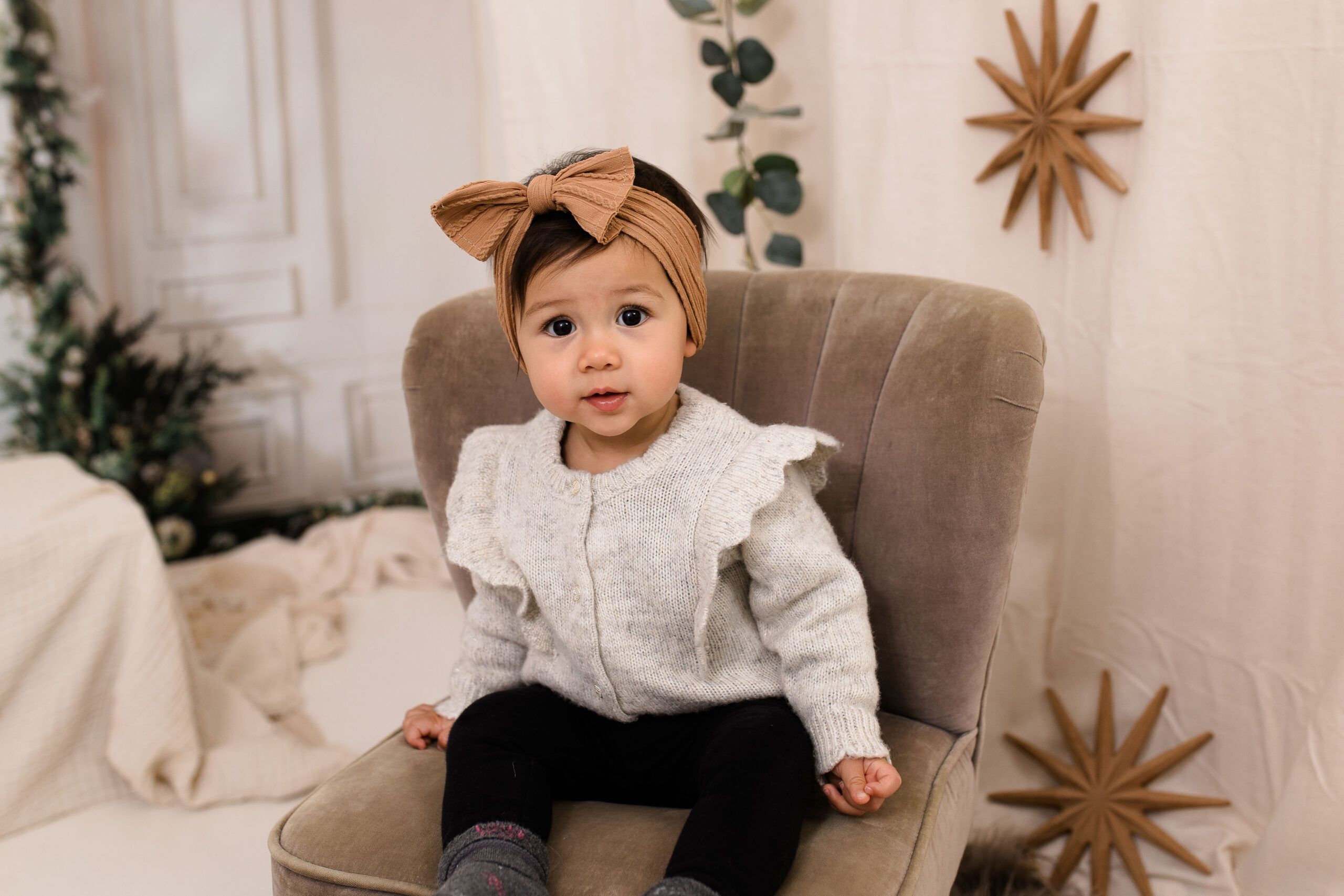 Eine Familie sitzt lachend in einem weihnachtlich dekorierten Studio in Rodgau, fotografiert von Julia Pitz.